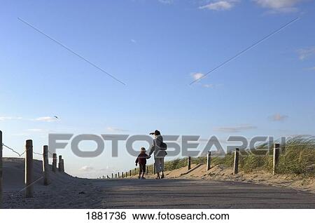 Mother And Daughter Walking Along Path Towards Beach View Large Photo Image Stock Photograph - Mother And Daughter Walking Along Path Towards Beach. Fotosearch