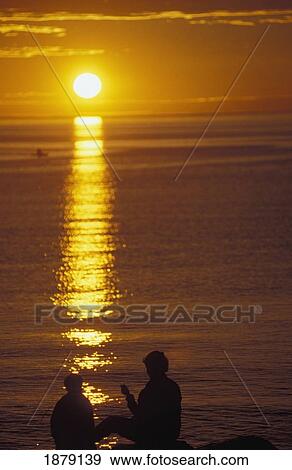 Stock Photo - Mother And Son On Banks Of Saint Lawrence River At Sunset. Fotosearch
