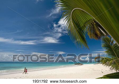 Stock Image - Mother & Child Going Jogging Along Beach Near Oistins, Barbados.. Fotosearch