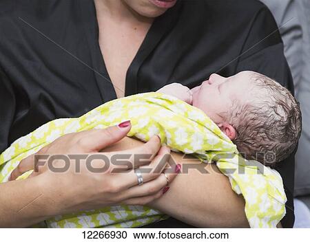 Mother holding newborn baby girl in delivery room; Edmonton, Alberta, Canada View Large Photo Image Stock Image - Mother holding newborn baby girl in delivery room; Edmonton, Alberta, Canada. Fotosearch