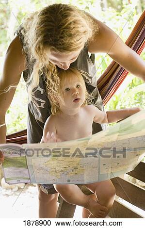 Stock Image - Mother With Child Looking At A Map. Fotosearch