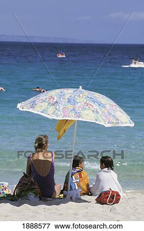 Mother With Daughters Under Umbrella On The Beach View Large Photo Image Stock Photo - Mother With Daughters Under Umbrella On The Beach. Fotosearch