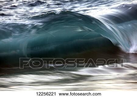 Stock Image - Motion blur of fast moving wave; Hawaii, United States of America. Fotosearch