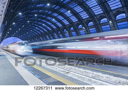 Motion blur of speeding train in train station; Milan, Lombardy, Italy View Large Photo Image Stock Image - Motion blur of speeding train in train station; Milan, Lombardy, Italy. Fotosearch