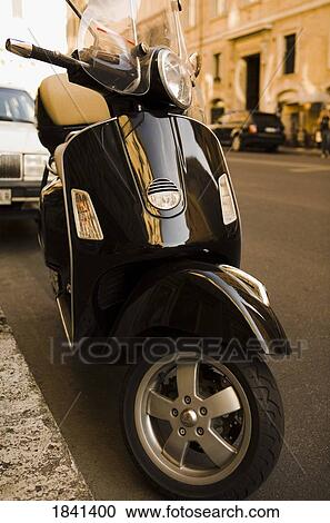 Stock Image - Motor Scooter Parked On Street; Rome, Italy. Fotosearch