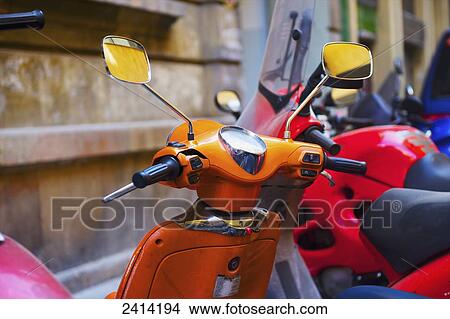 Motor scooters parked in a row; Barcelona, Spain View Large Photo Image Picture - Motor scooters parked in a row; Barcelona, Spain. Fotosearch