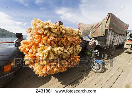 Stock Image - Motorcycle laden with prawn crackers on board the car ferry between Parapat and Samosir Island, Lake Toba, North Sumatra, Indonesia. Fotosearch