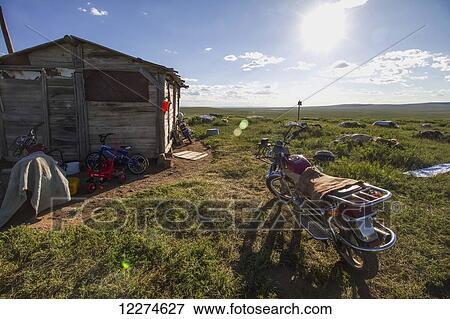 Stock Photo - Motorcycle parked next to a wooden house, Khogno Khan Uul Nature Reserve, Arkhangai Province, Mongolia. Fotosearch