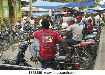 Stock Photo - Motorcycle Taxi Waiting For Passenger At Street Market; Neiba, Baoruco, Dominican Republic. Fotosearch