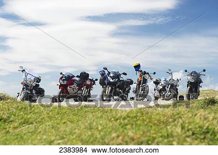 Picture - Motorcycles parked in a row; South Island, New Zealand. Fotosearch