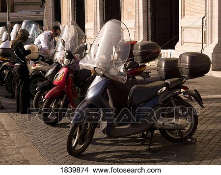 Motorcycles Parked In Front Of Old Building; Rome, Italy View Large Photo Image Picture - Motorcycles Parked In Front Of Old Building; Rome, Italy. Fotosearch