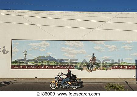 Motorcyclist Riding A Harley Davidson Passing A Cowboy Rancher Mural, Alpine, Texas, Usa View Large Photo Image Stock Photo - Motorcyclist Riding A Harley Davidson Passing A Cowboy Rancher Mural, Alpine, Texas, Usa. Fotosearch