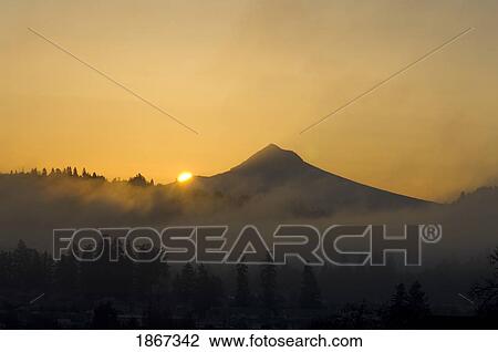 Stock Image - Mount Hood In A Foggy Sunrise From Powell Butte, Portland, Oregon, United States Of America. Fotosearch