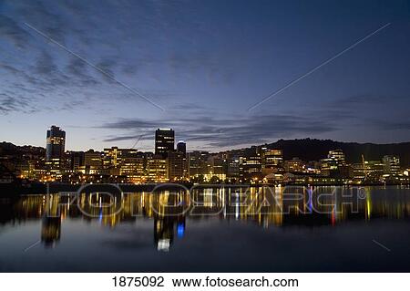 Stock Image - Mount Wellington, Auckland City, New Zealand; City Centre Illuminated At Night And Reflecting In The Water. Fotosearch