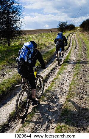 Mountain Bikers On The Ridgeway. Ancient Trackway Described As Britain's Oldest Road, In Use Since Neolithic Times. Now A Restricted Byway. Vale Of The White Horse, Oxfordshire, Uk View Large Photo Image Picture - Mountain Bikers On The Ridgeway. Ancient Trackway Described As Britain's Oldest Road, In Use Since Neolithic Times. Now A Restricted Byway. Vale Of The White Horse, Oxfordshire, Uk. Fotosearch