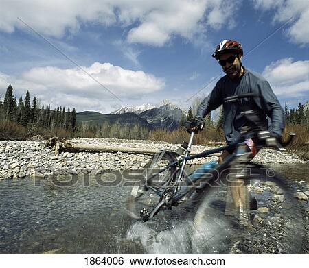 Stock Photograph - Mountain Biking In The Rocky Mountains; Kananaskis, Alberta, Canada. Fotosearch