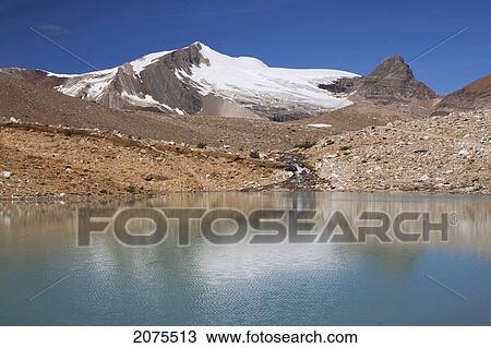 Stock Image - Mountain Lake With Glacier And Mountain Reflection And Blue Sky; Field British Columbia Canada. Fotosearch