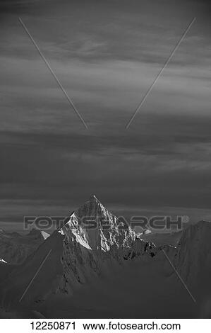 Mountain peak illuminated by sunlight; Haines, Alaska, United States of America View Large Photo Image Stock Image - Mountain peak illuminated by sunlight; Haines, Alaska, United States of America. Fotosearch