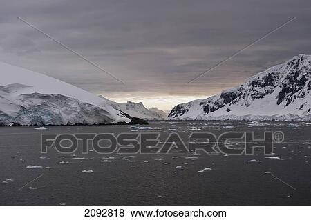 Stock Photo - Mountains Along The Coastline At Sunset; Antarctica. Fotosearch