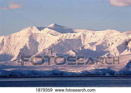 Stock Photo - Mountains Covered In Snow By The Coast. Fotosearch