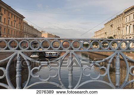 Stock Photo - Moyka River Through The Bridge Railing; St. Petersburg Russia. Fotosearch