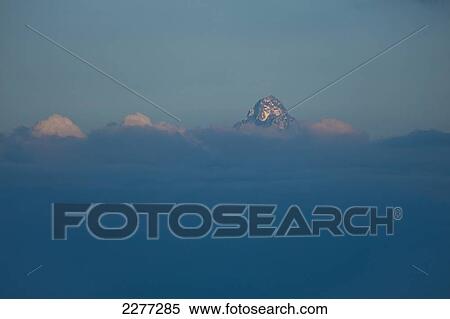 Mt Kenya poking out above clouds at dusk, Ol Pejeta Conservancy; Kenya View Large Photo Image Stock Photography - Mt Kenya poking out above clouds at dusk, Ol Pejeta Conservancy; Kenya. Fotosearch