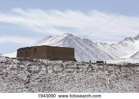 Stock Image - Mud House At The Hajigak Pass With The Koh-I-Baba Range As A Backdrop, Vardak Province, Afghanistan. Fotosearch