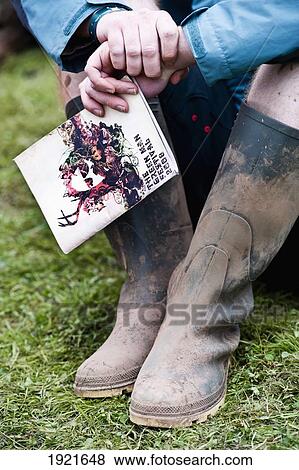 Stock Photo - Muddy boots at Green Man Festival, Glanusk Park, Brecon Beacons, Wales, UK. Fotosearch
