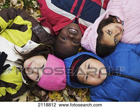 Multi-Ethnic New Canadian Children Lying In Autumn Leaves Outside Esl School; Guelph Ontario Canada View Large Photo Image Stock Image - Multi-Ethnic New Canadian Children Lying In Autumn Leaves Outside Esl School; Guelph Ontario Canada. Fotosearch