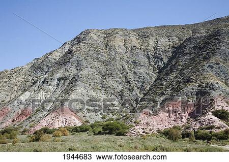 Stock Image - Multicolored mountains of the Quebrada de Humahuaca between the towns of Tilcara and Hornillos, Jujuy, Argentina. Fotosearch