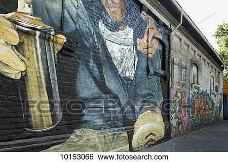 Mural of a graffiti artist with a can of spray paint painted on a building wall; Santiago, Santiago Metropolitan Region, Chile View Large Photo Image Stock Photograph - Mural of a graffiti artist with a can of spray paint painted on a building wall; Santiago, Santiago Metropolitan Region, Chile. Fotosearch