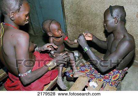 Mursi tribal man working as assistant nurse for Christian missionaries conducting a Malaria test on a small child. Makki / South Omo / Southern Nations, Nationalities & People's Region (Ethiopia). View Large Photo Image Stock Photo - Mursi tribal man working as assistant nurse for Christian missionaries conducting a Malaria test on a small child. Makki / South Omo / Southern Nations, Nationalities & People's Region (Ethiopia).. Fotosearch