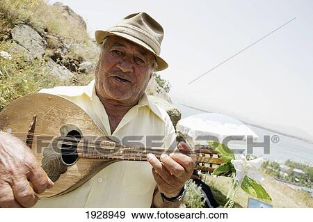 Stock Photo - Musician Playing Above Lake Sevan. Fotosearch
