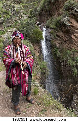 Stock Image - Musician Playing Flute By Waterfall At Archaeological Park Of Pisac; Pisac Peru. Fotosearch