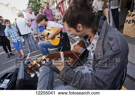 Stock Image - Musicians, Columbia Road Flower Market; London, England. Fotosearch