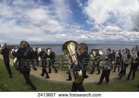 Musicians playing brass instruments marching at the water's edge; South Shields, Tyne and Wear, England View Large Photo Image Stock Photo - Musicians playing brass instruments marching at the water's edge; South Shields, Tyne and Wear, England. Fotosearch