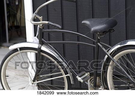 Stock Photo - Muskokas, Ontario, Canada; Vintage Bicycle Resting Against A Wall. Fotosearch