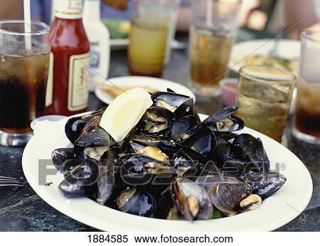 Stock Photography - Mussels On Plate On A Picnic Table. Fotosearch
