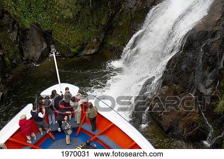 Mv Skorpios Next To A Waterfall In Quitralco Fjord, Aysen Region, Chile View Large Photo Image Stock Image - Mv Skorpios Next To A Waterfall In Quitralco Fjord, Aysen Region, Chile. Fotosearch