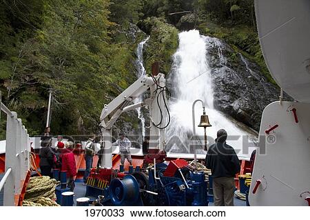 Mv Skorpios Next To A Waterfall In Quitralco Fjord, Aysen Region, Chile View Large Photo Image Stock Image - Mv Skorpios Next To A Waterfall In Quitralco Fjord, Aysen Region, Chile. Fotosearch