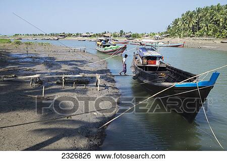 Myanmar (Burma), Boat on river and village; irrawaddyi division View Large Photo Image Stock Photograph - Myanmar (Burma), Boat on river and village; irrawaddyi division. Fotosearch