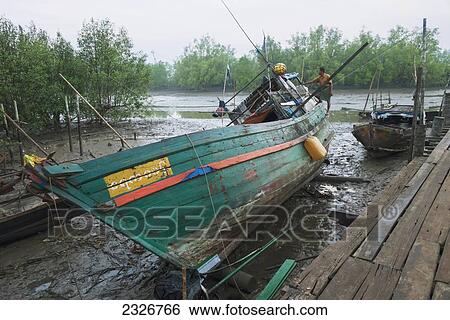 Myanmar (Burma), Irrawaddyi division, Wooden fishing boat at low tide; Nag Yoke Kaung View Large Photo Image Stock Photograph - Myanmar (Burma), Irrawaddyi division, Wooden fishing boat at low tide; Nag Yoke Kaung. Fotosearch