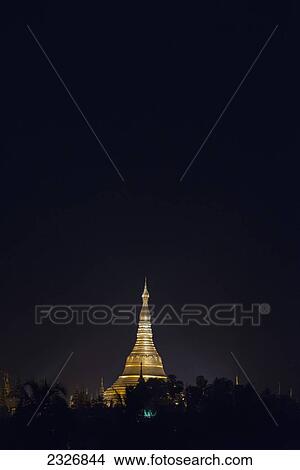 Myanmar (Burma), Shwedagon pagoda lit up at night; Yangon View Large Photo Image Picture - Myanmar (Burma), Shwedagon pagoda lit up at night; Yangon. Fotosearch