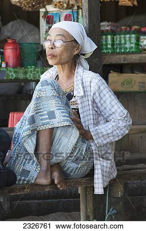 Myanmar, Portrait of an elderly woman waiting for public transport; Irrawaddyi division View Large Photo Image Stock Image - Myanmar, Portrait of an elderly woman waiting for public transport; Irrawaddyi division. Fotosearch