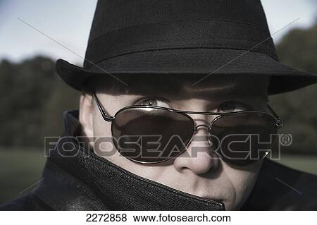Stock Photo - Mysterious young man in a fedora and sunglasses; hartford connecticut usa. Fotosearch