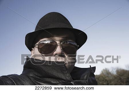Stock Photo - Mysterious young man in a fedora and sunglasses; hartford connecticut usa. Fotosearch
