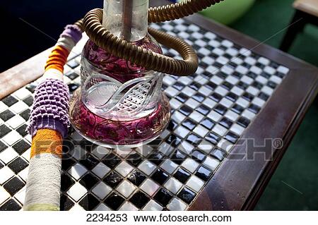 Stock Image - Narghile smoking pipe as smoked in the Tophane Narghile Cafes, close to the Istanbul Modern, Istanbul, Turkey. Photo. Fotosearch