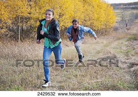 Native American boy and girl chasing each other through a field; Rossburn, Manitoba, Canada View Large Photo Image Stock Image - Native American boy and girl chasing each other through a field; Rossburn, Manitoba, Canada. Fotosearch