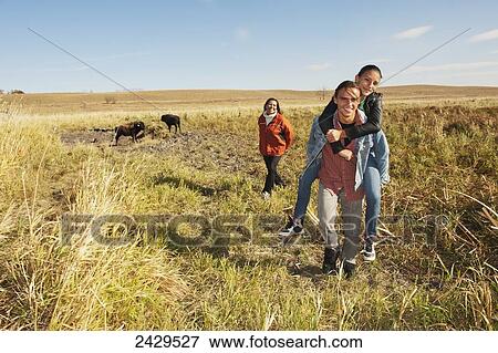 Native American family walking through a buffalo ranch; Rossburn, Manitoba, Canada View Large Photo Image Stock Photo - Native American family walking through a buffalo ranch; Rossburn, Manitoba, Canada. Fotosearch
