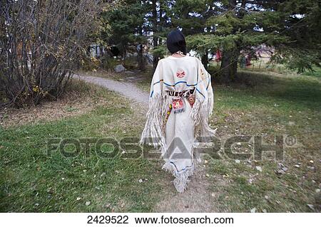 Native American woman walking outside wearing a traditional dress; Rossburn, Manitoba, Canada View Large Photo Image Stock Image - Native American woman walking outside wearing a traditional dress; Rossburn, Manitoba, Canada. Fotosearch
